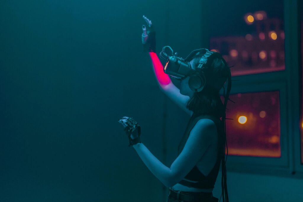 pexels-photo-8721340-8721340 A woman interacts with a virtual environment using advanced VR headset at night.
